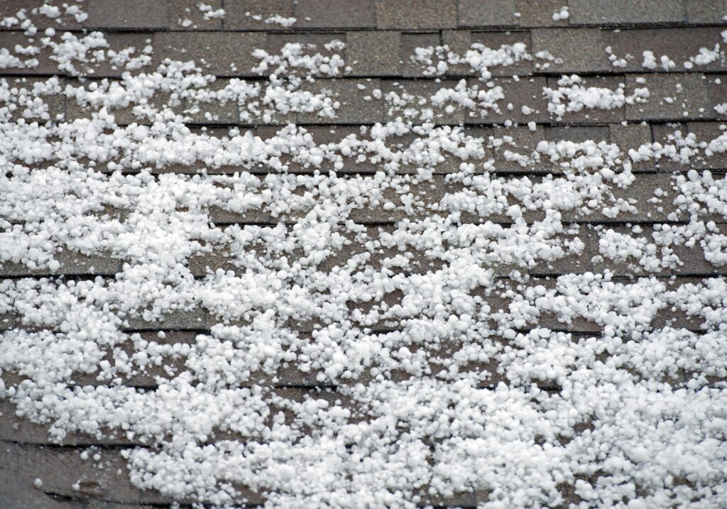 Winter Weather Leaves Hail And Ice On An Asphalt Shingle Roof In Milford MI